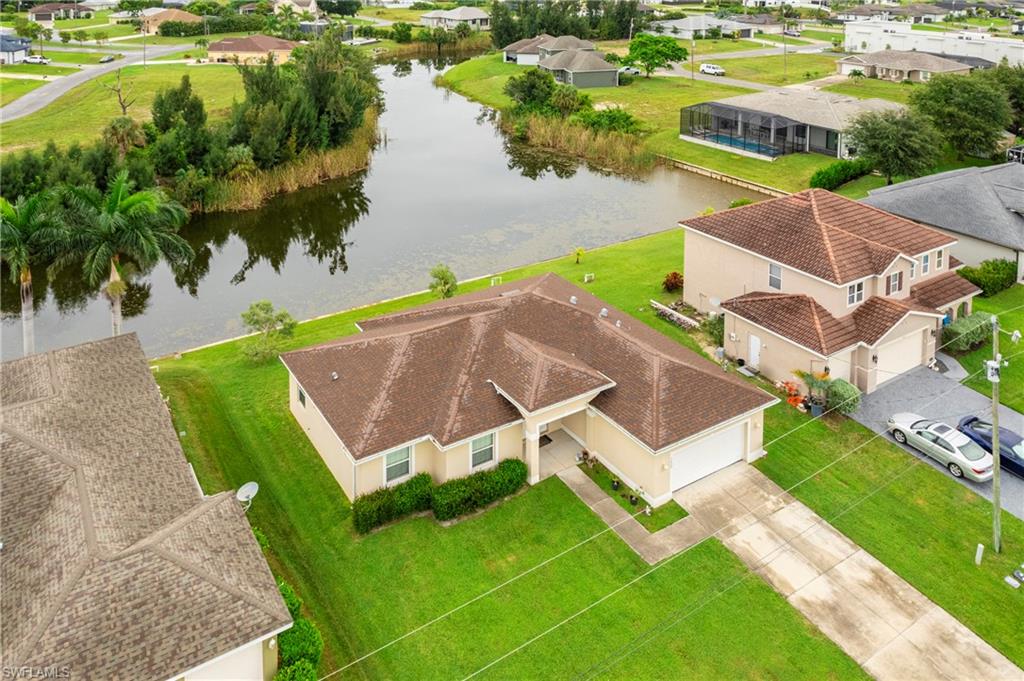 Aerial view of residential area featuring a nearby body of water