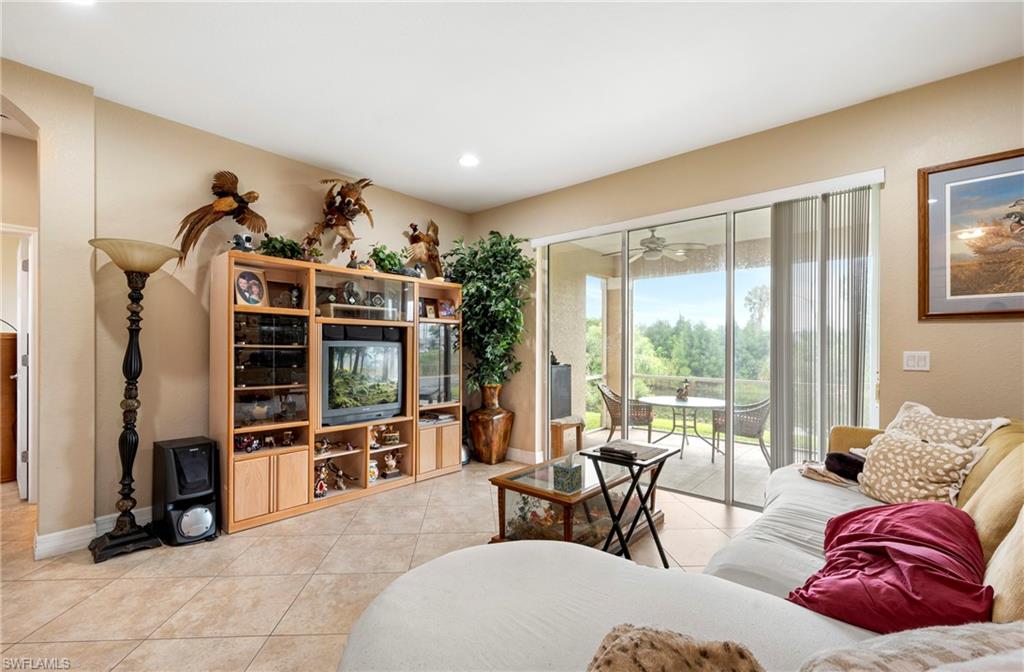Living room with light tile patterned flooring, recessed lighting, and a ceiling fan