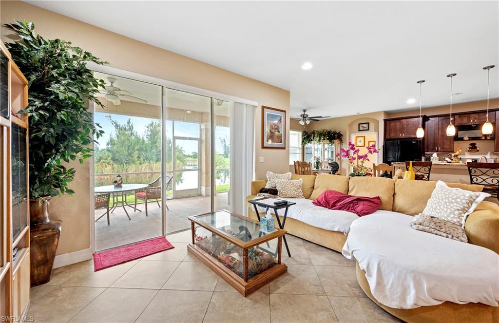 Living room with light tile patterned floors, recessed lighting, and ceiling fan
