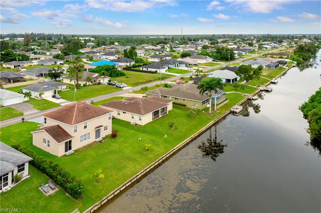 Aerial view of residential area featuring a large body of water