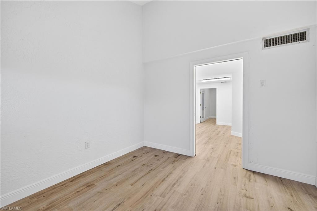 Spare room with light wood-type flooring and baseboards