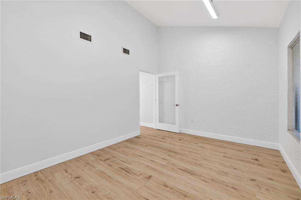 Empty room with light wood-type flooring and baseboards