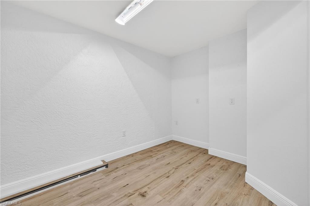 Spare room featuring light wood finished floors and baseboard heating