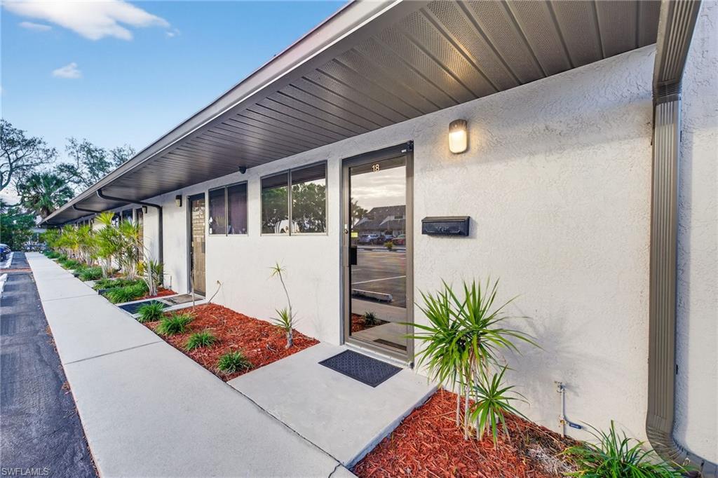 View of exterior entry featuring stucco siding