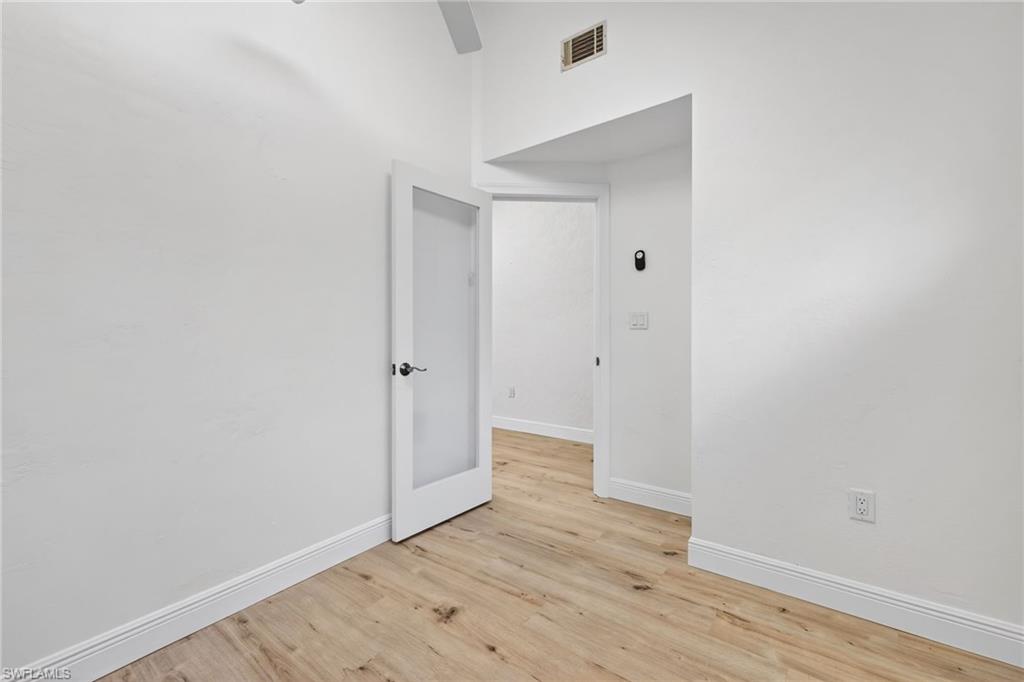 Empty room featuring baseboards and light wood-style flooring