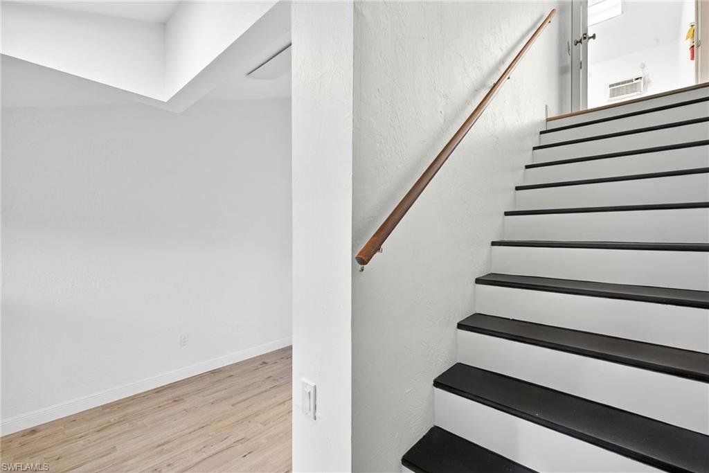 Stairs featuring wood finished floors and baseboards