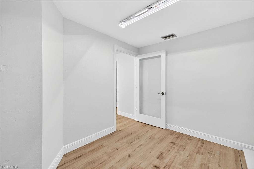 Spare room with light wood-type flooring and baseboards