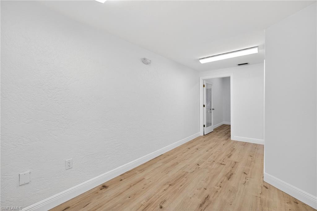 Unfurnished room with baseboards and light wood-style flooring