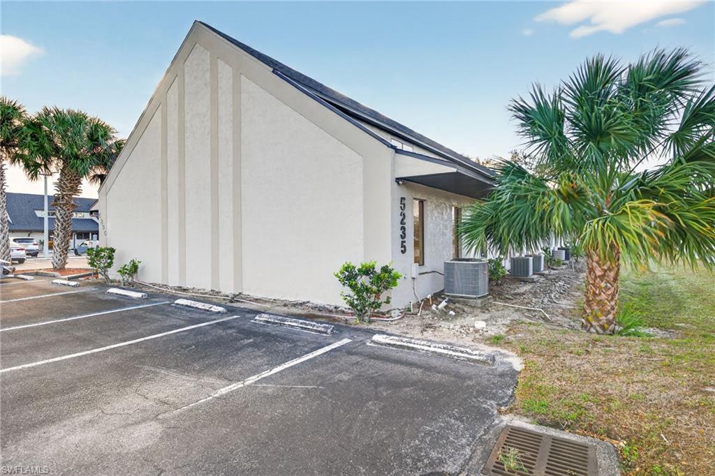 View of property exterior featuring stucco siding and uncovered parking
