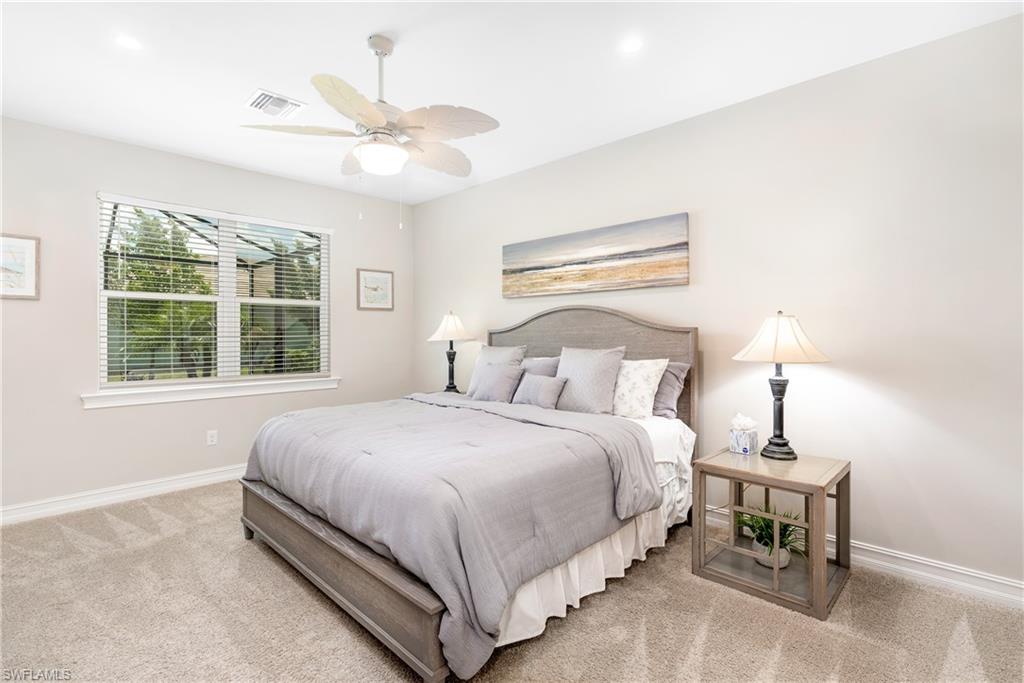 Carpeted bedroom featuring ceiling fan and recessed lighting
