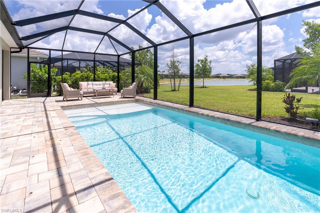 Swimming pool featuring a lawn and a lanai