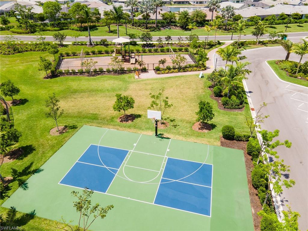 View of sport court featuring a residential view, community basketball court, and a lawn