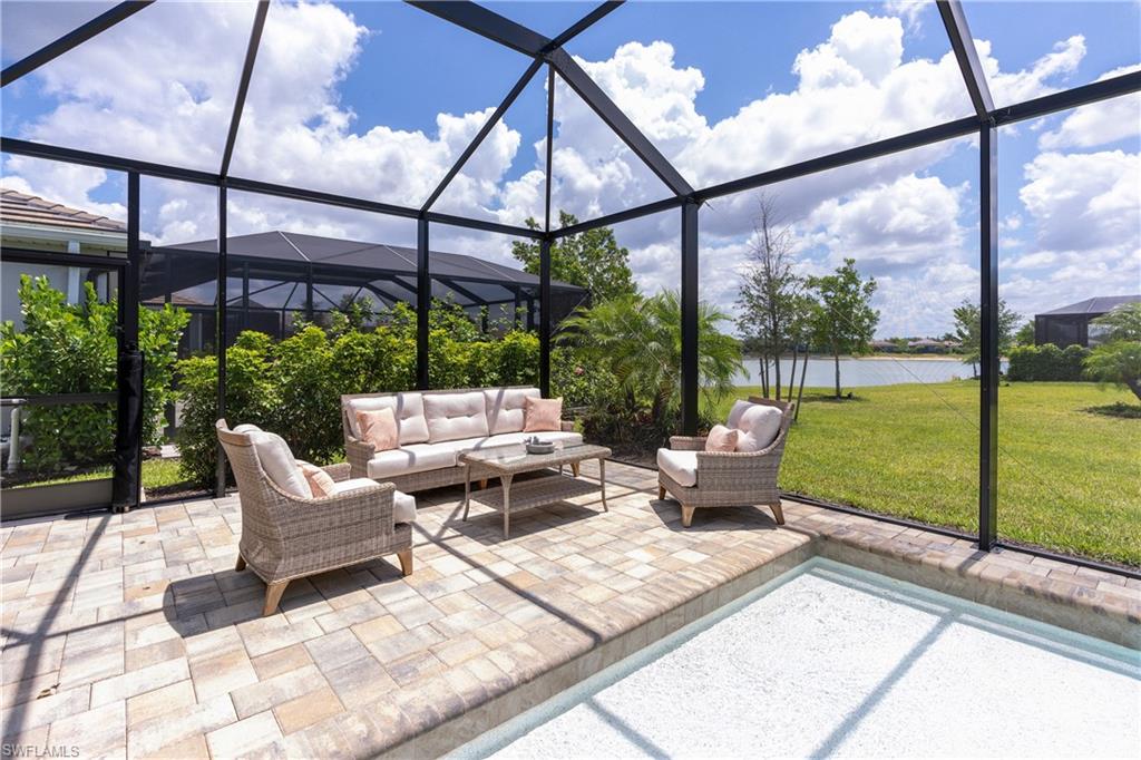 View of patio with glass enclosure and a sunroom