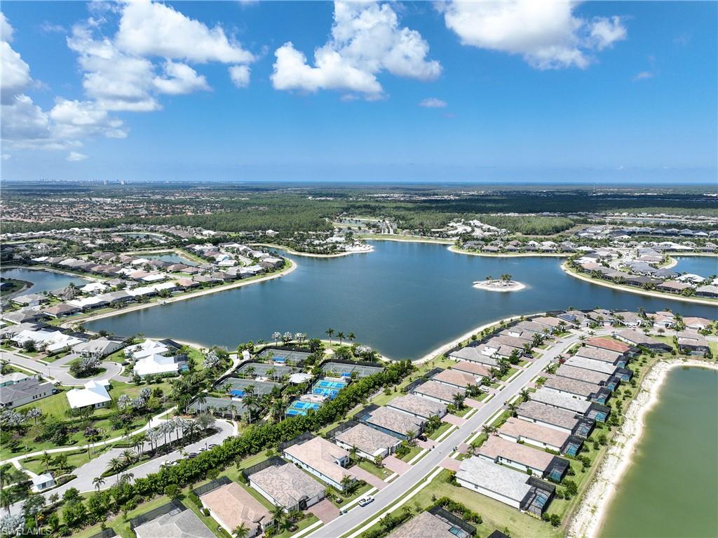 Aerial view of residential area featuring a nearby body of water