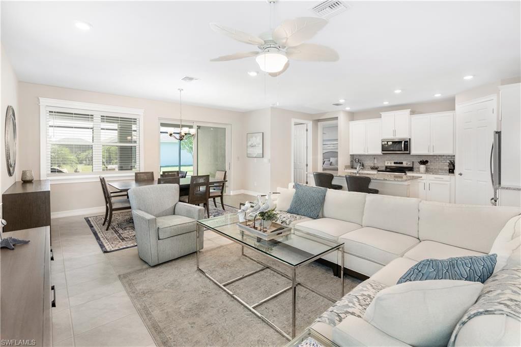 Living room with recessed lighting, a chandelier, light tile patterned floors, and ceiling fan