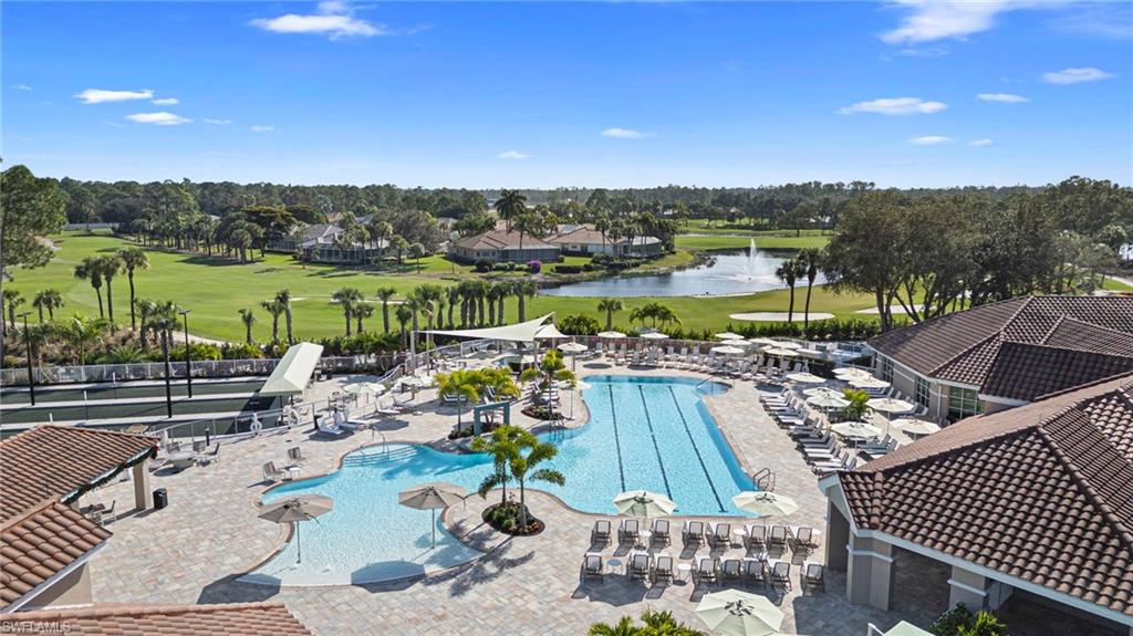 Community pool featuring golf course view, a water view, and a patio area