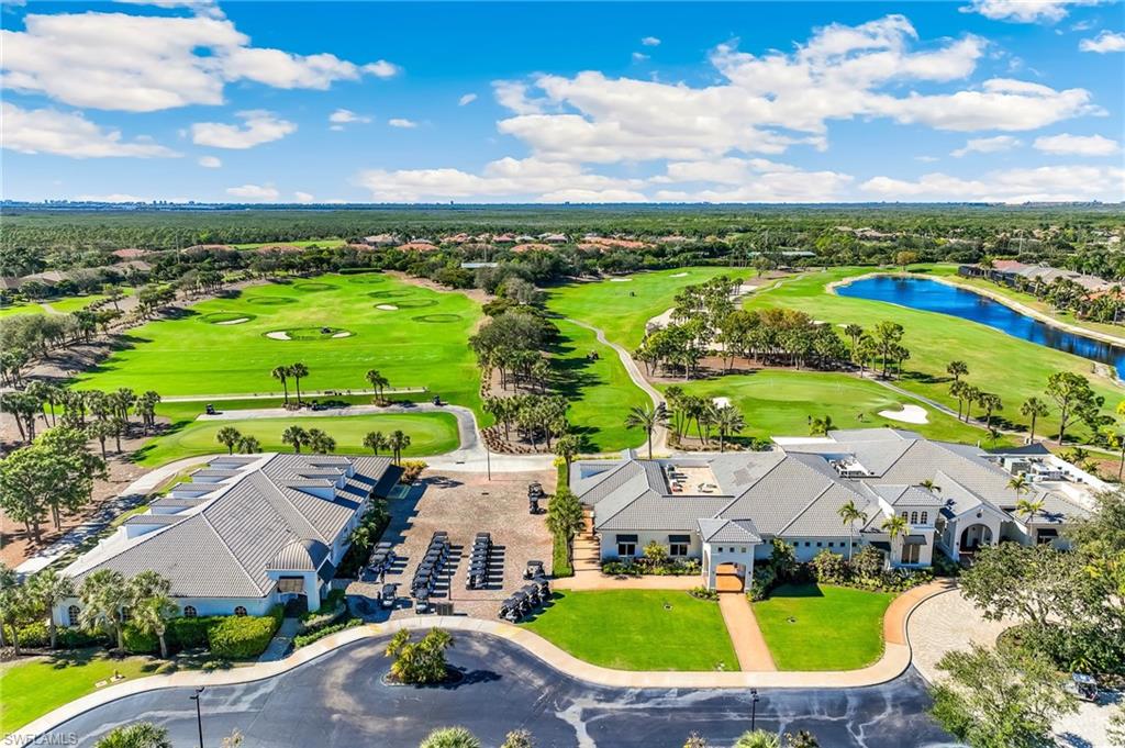 Aerial perspective of suburban area featuring a large body of water and a local golf course