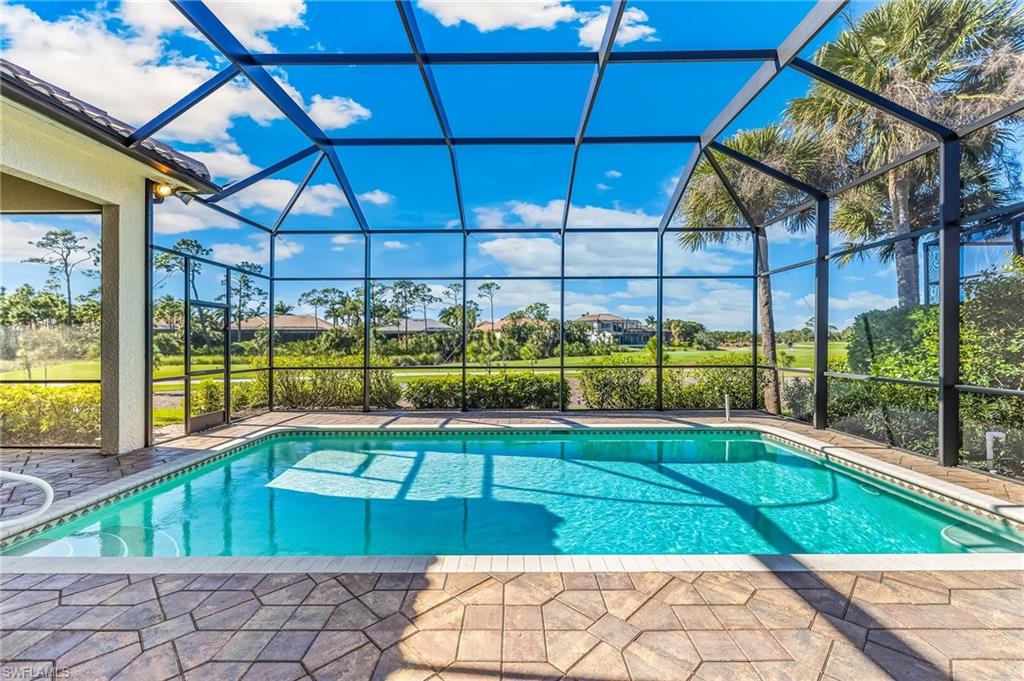 Outdoor pool featuring a sunroom, a lanai, and a patio area