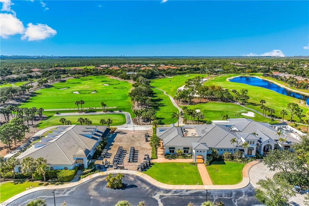Aerial perspective of suburban area with a nearby body of water and a golf course