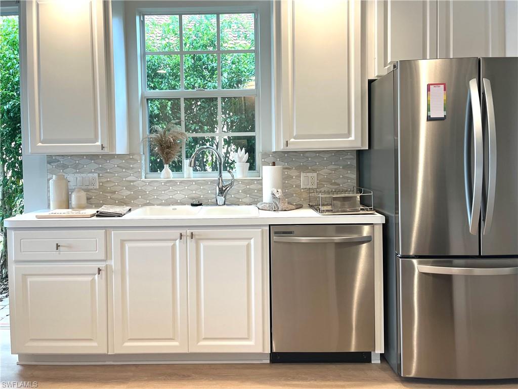 Kitchen w/stainless steel appliances and new side yard privacy hedge