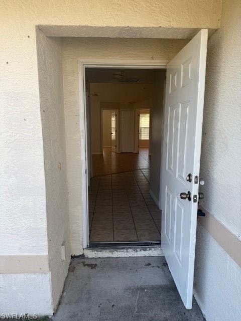 Entrance to property featuring stucco siding