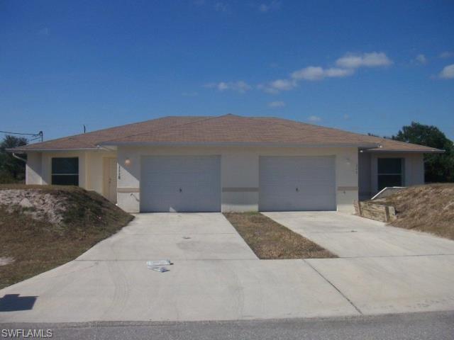 Ranch-style home with stucco siding, driveway, and a garage