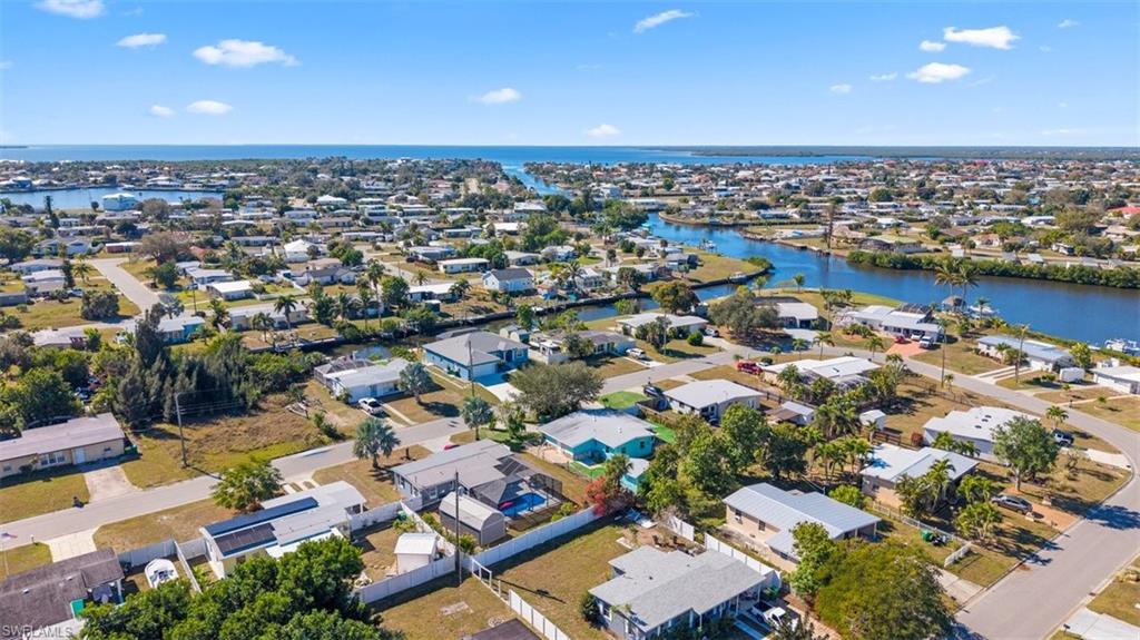 Aerial view of property's location featuring nearby suburban area and a nearby body of water