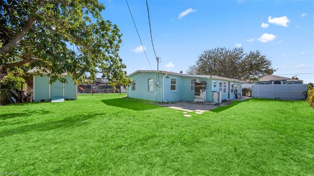 Back of property with stucco siding and a patio