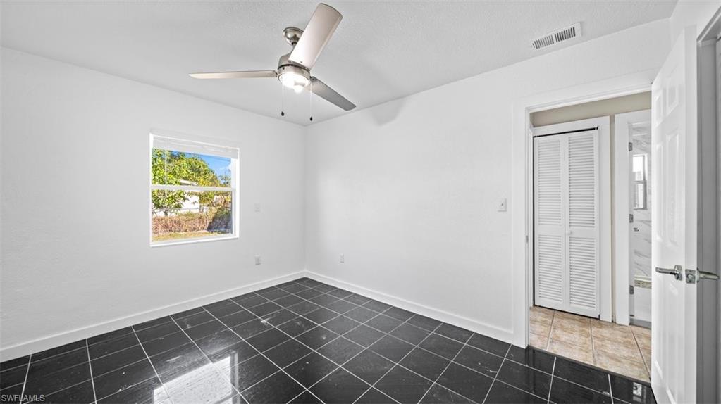 Unfurnished room with baseboards and ceiling fan