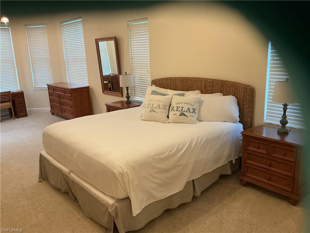 Bedroom with light colored carpet