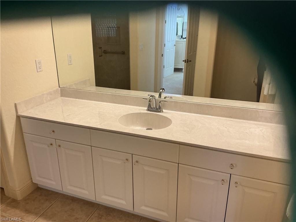 Bathroom featuring vanity and light tile patterned flooring