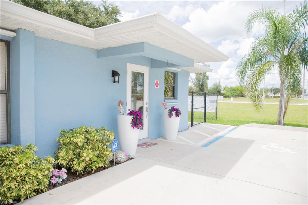 Entrance to property featuring stucco siding and a gate