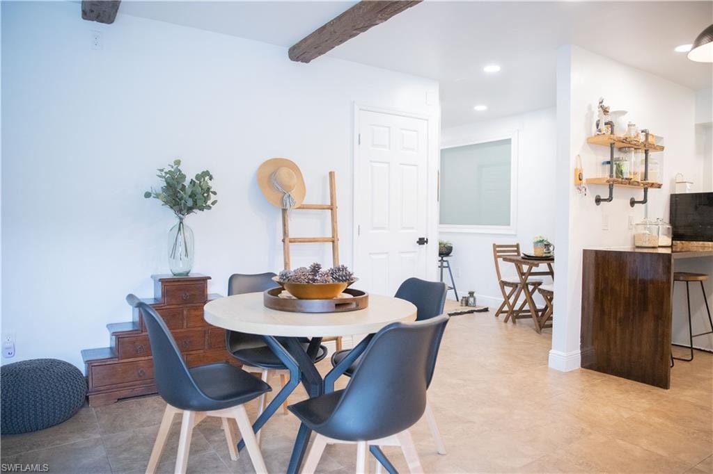 Dining room with beam ceiling and recessed lighting