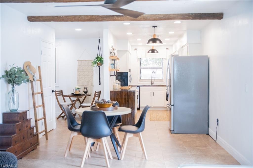 Dining area featuring recessed lighting, beamed ceiling, and light tile patterned floors