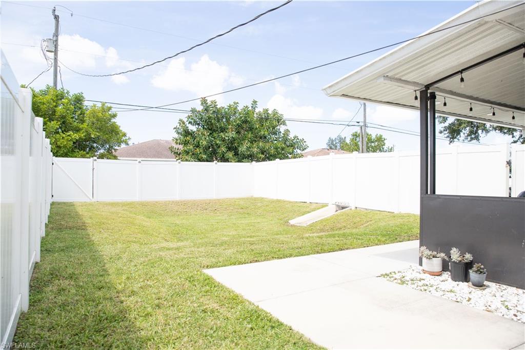 Fenced backyard with a patio