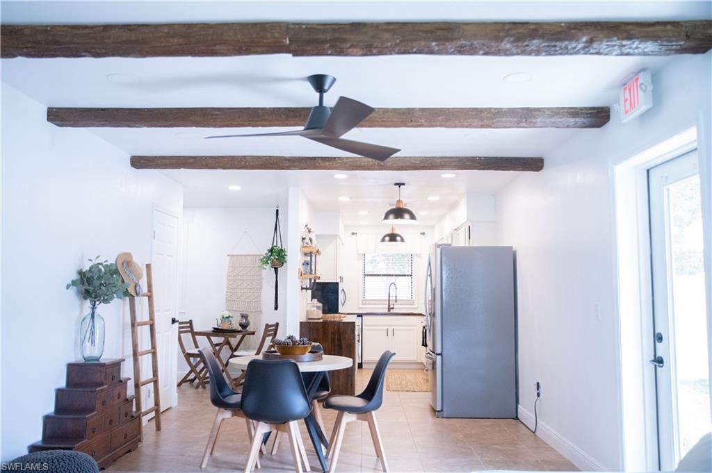 Dining area featuring recessed lighting, ceiling fan, light tile patterned floors, and beam ceiling