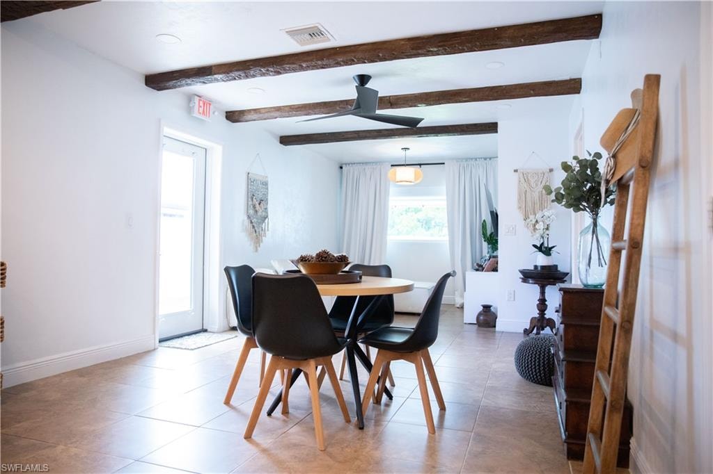 Tiled dining room with a ceiling fan, beamed ceiling, and recessed lighting