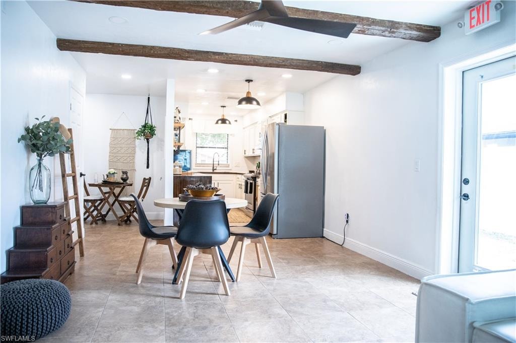Dining area with ceiling fan, recessed lighting, and beam ceiling