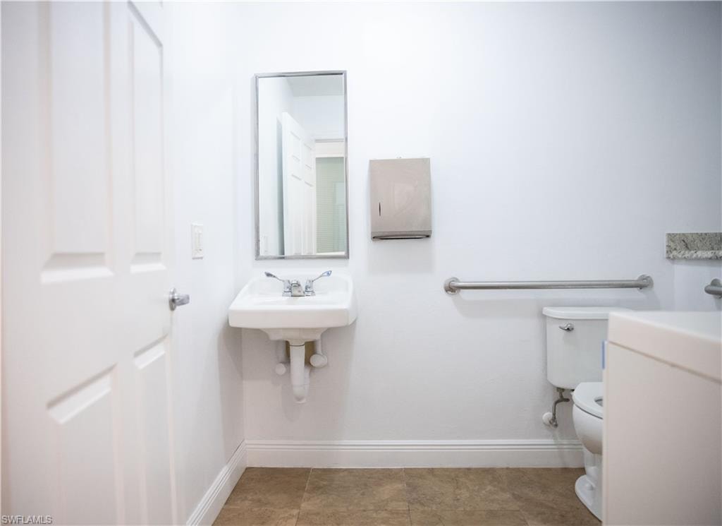 Bathroom featuring baseboards and toilet