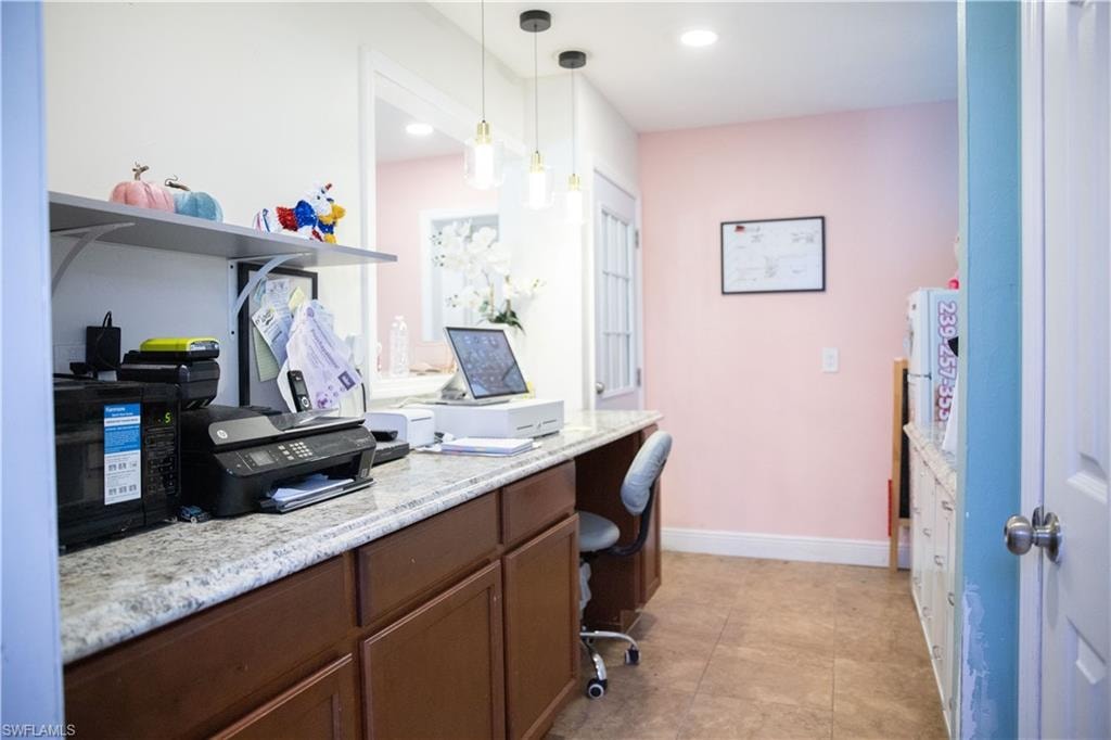 Home office with built in desk and recessed lighting