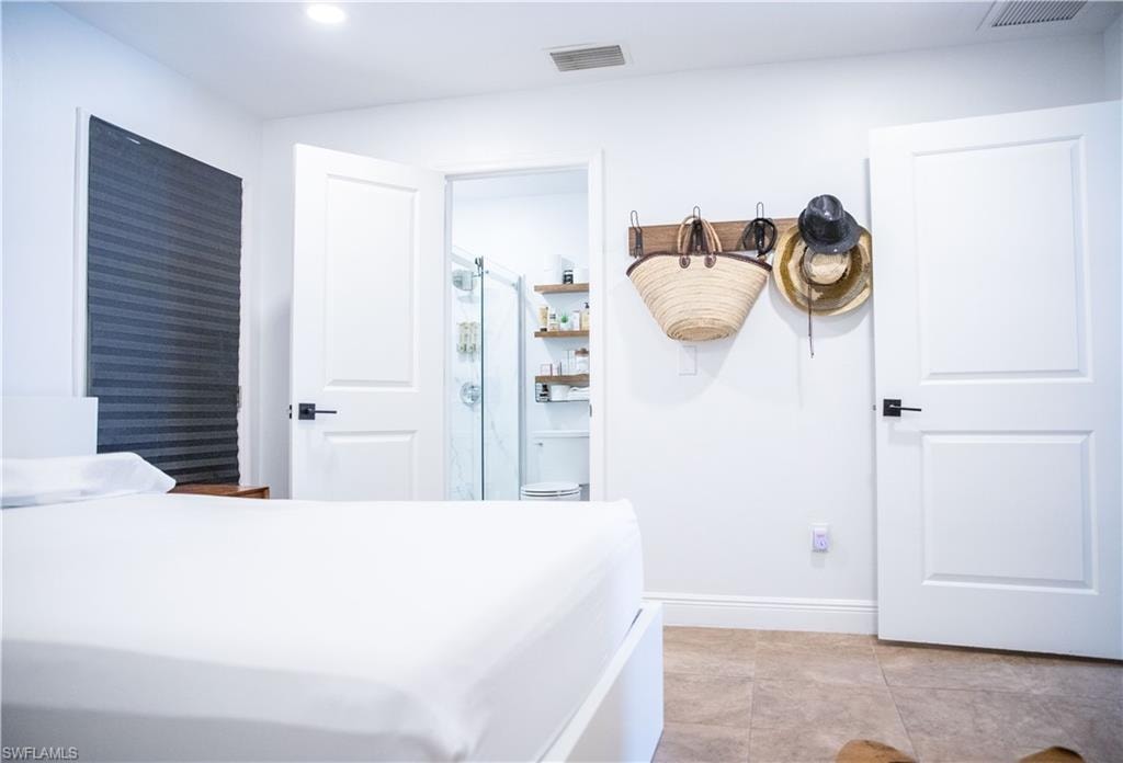 Bedroom featuring baseboards and light tile patterned flooring