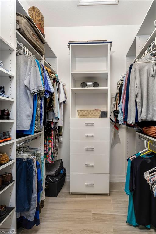Spacious closet with light wood-style flooring