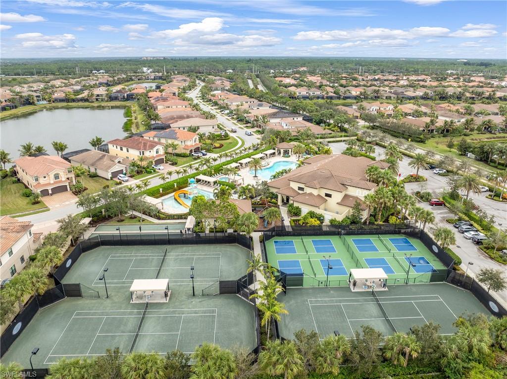 Aerial perspective of suburban area with a pool area and a nearby body of water