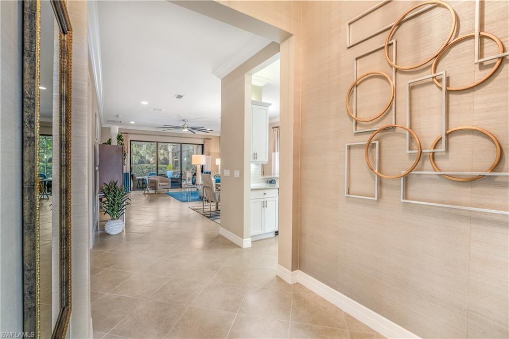 Hall featuring ornamental molding, light tile patterned floors, and recessed lighting