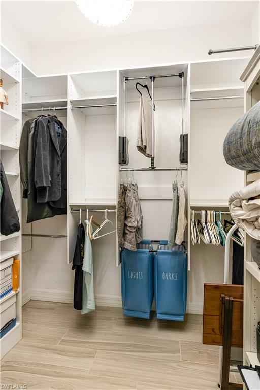 Walk in closet featuring wood finish floors
