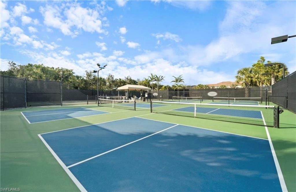 View of tennis court featuring a gazebo and community basketball court