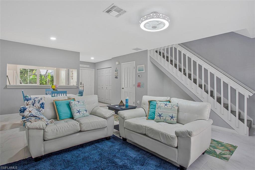 Living room with stairs and recessed lighting