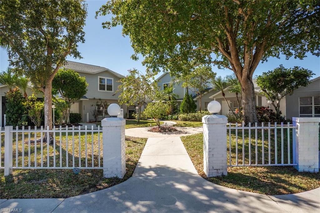 Obstructed view of property with a fenced front yard