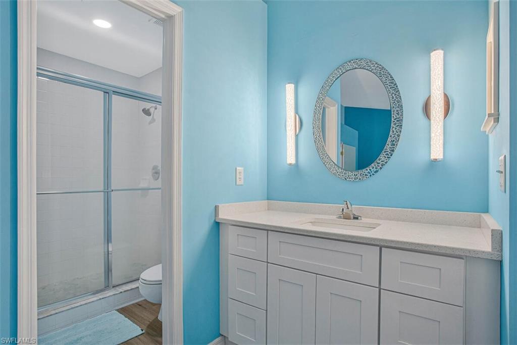 Full bathroom featuring a stall shower and vanity