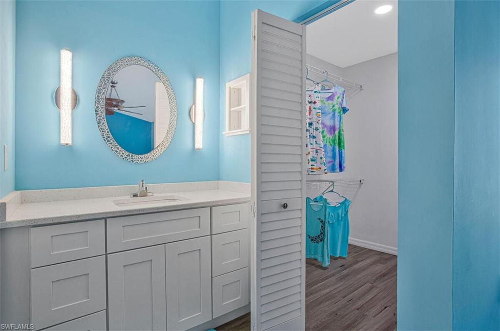Bathroom with vanity and dark wood-style flooring